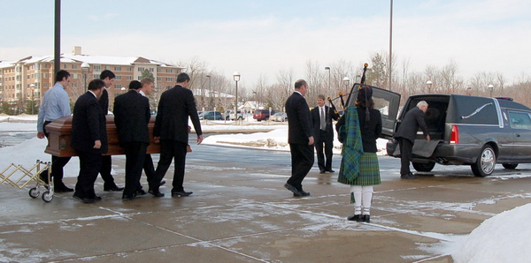 Kim Montgomery Johnson piping the funeral recessional out to the hearse